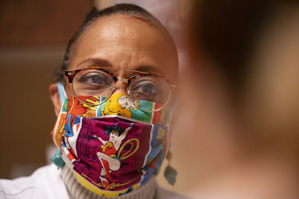 Dr. Verna Thornton spoke with a patient while donning her Wonder Woman face mask recently at Community Memorial Hospital in Cloquet, Minn.
