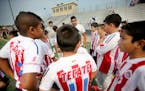 Angel Ramirez Diaz, center, gave his team "Chivitas,: a pep talk before their game during a soccer tournament, Saturday, August 29, 2015 at Holy Angel
