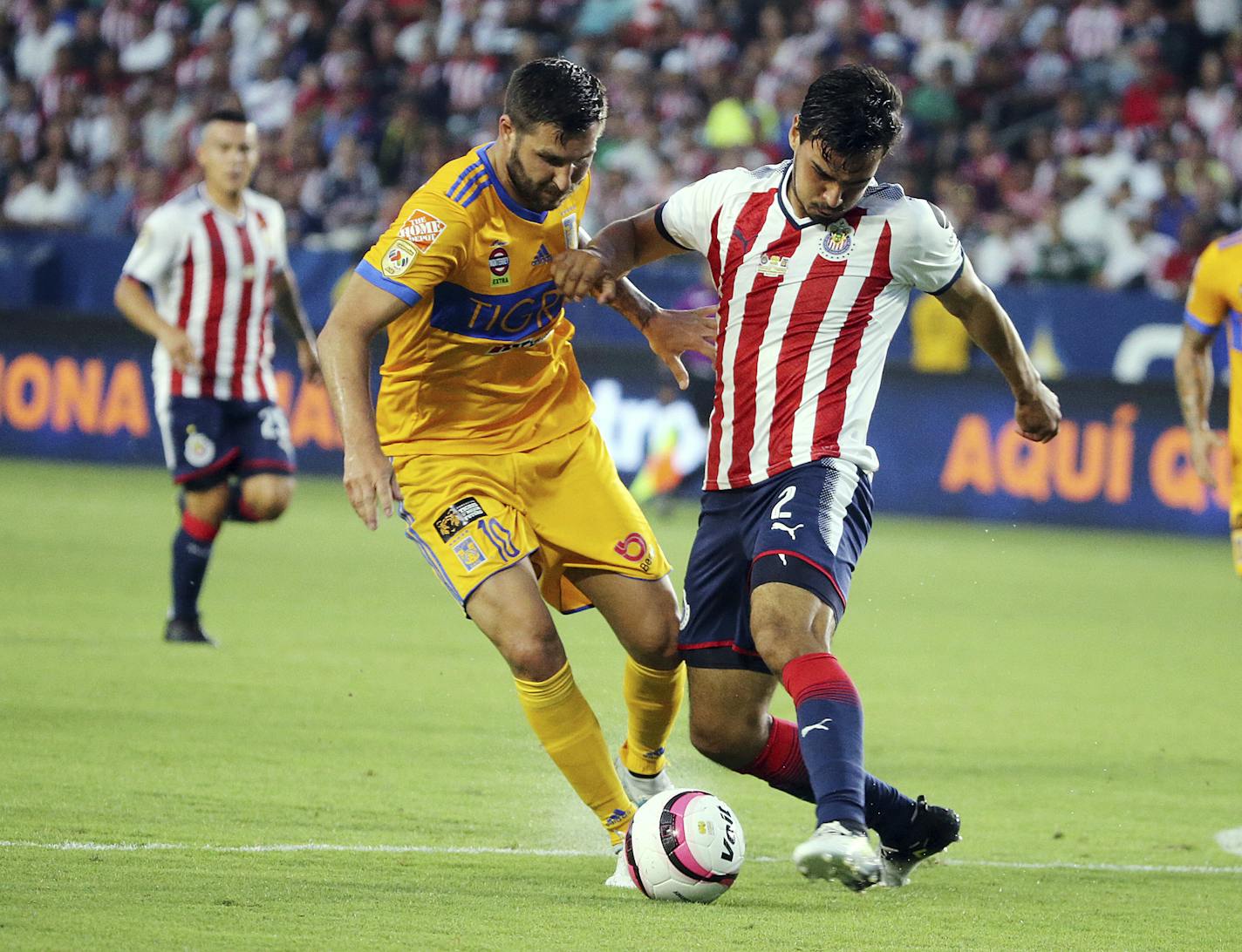 Tigre UANL orward Andre-Pierre Gignac (10), left, and Chivas de Guadalajara defender Oswaldo Alanis (2) battle in the first half of a Champion of Champions (Campeon de Campeones) soccer match in Carson, Calif., Sunday, July 16, 2017. (AP Photo/Reed Saxon)