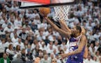 Suns forward Kevin Durant (35) lays the ball in past Timberwolves center Rudy Gobert (27) in the first quarter of a first-round NBA playoff game at Ta