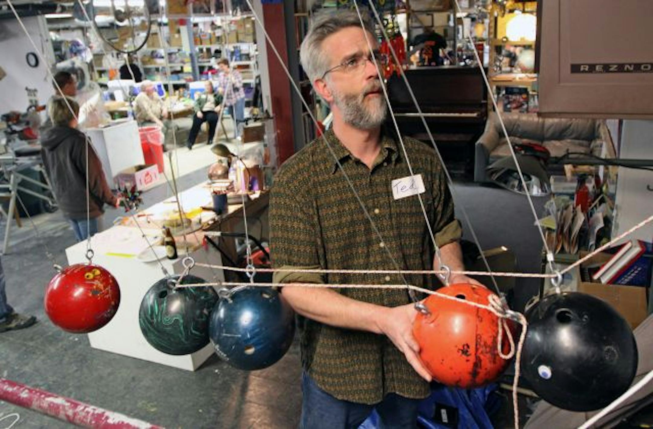 Ted Goessling tried to figure out how to make bowling balls pull a pulley as part of a 150-foot causation machine during a Studio Bricolage class at Leonardo's Basement in south Minneapolis.