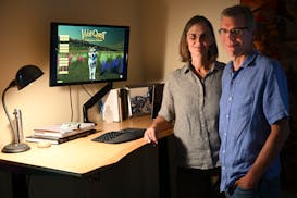 "WolfQuest" producer and designer Dave Schaller and content developer Susan Nagel in their home office Monday in St. Paul.  A new edition of their gam
