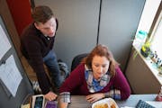 Crisis practitioners Candice Brumm and Andrew Baur consult with each other over a client assessment at Canvas Health in Coon Rapids, on Thursday, Jan.