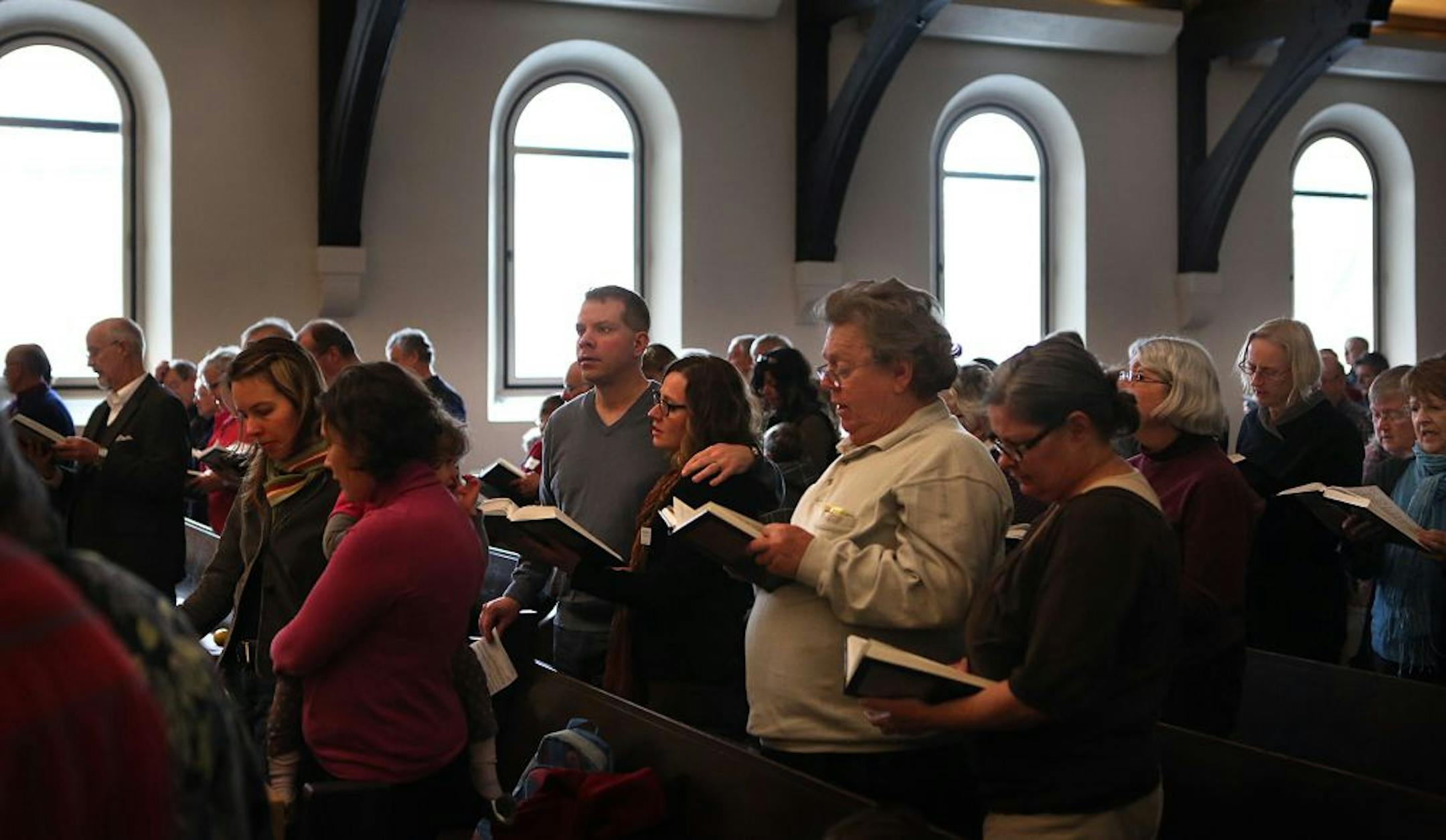 Congregants at the Unity Church-Unitarian in St. Paul joined in song during the church's fifth annual Black Friday service. The theme for the service was "Feeding the Spirit of the Feast Day of Consumption."