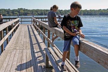 (middle to right) Jorden Mathison, age-14 1/2 and Beau Abell, age 7 1/2, from North Branch fished with their grandfather, Terry Abell of Newport MN., 