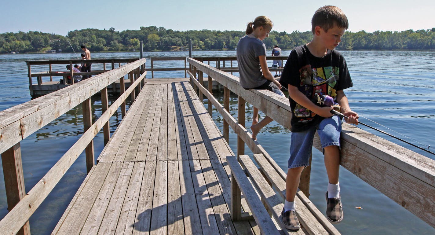 (middle to right) Jorden Mathison, age-14 1/2 and Beau Abell, age 7 1/2, from North Branch fished with their grandfather, Terry Abell of Newport MN., from the fishing pier at the Lake Elmo Park Reserve, Saturday, 9/10/11.] Bruce Bisping/Star Tribune. Jorden Mathison, Beau Abell and Terry Abell/source.