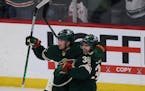 Minnesota Wild left wing Kevin Fiala (22) reacts with right wing Mats Zuccarello (36) after scoring the game winning goal in overtime against the Colo