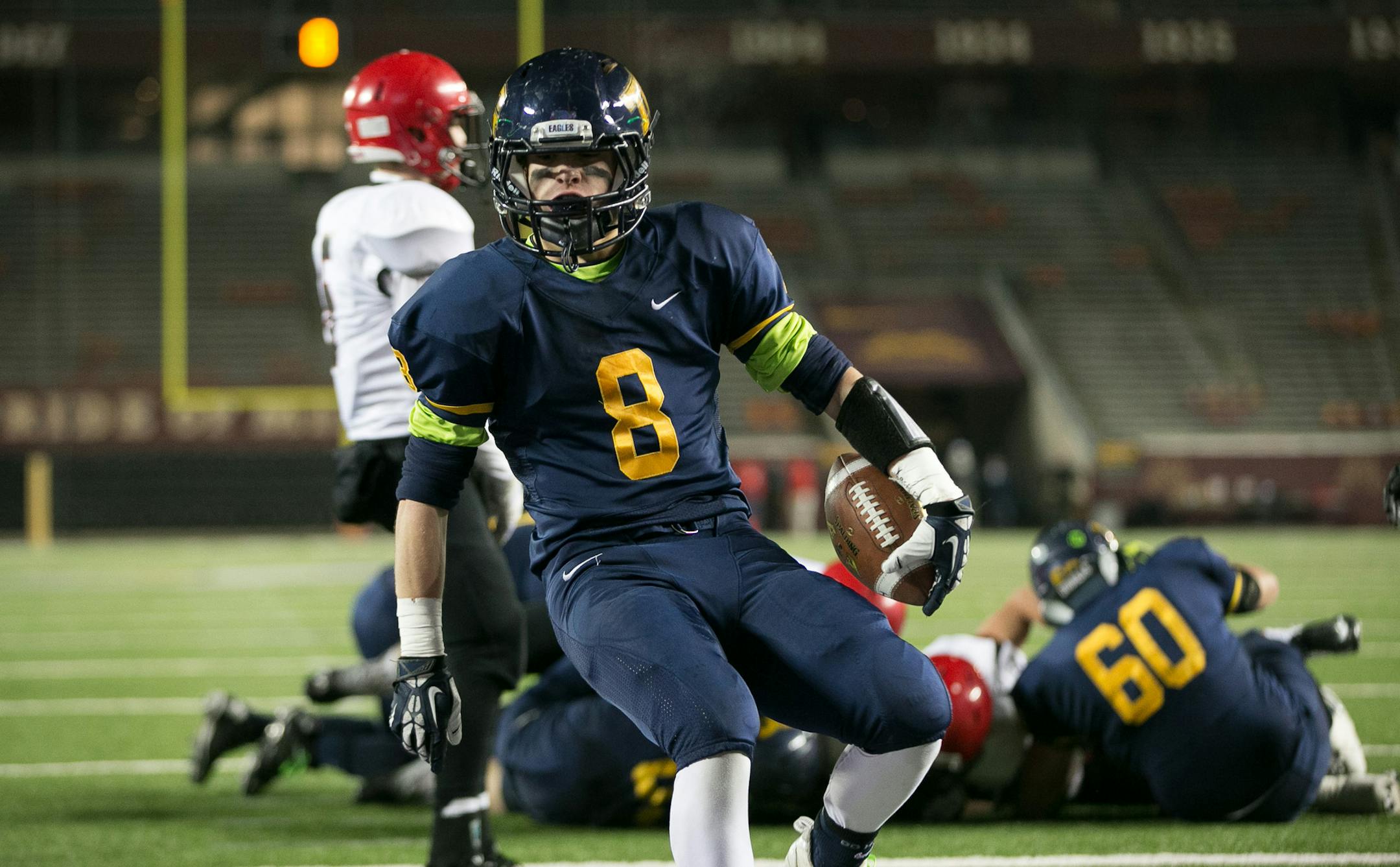 Totino-Grace wide receiver Ben Mezzenga (8) trots into the end zone for a second touchdown against Eden Prairie during the first quarter of Friday night's game. ] AARON LAVINSKY • aaron.lavinsky@startribune.com Totino-Grace takes on Eden Prairie in the Class 6A Prep Bowl Friday, Nov. 21, 2014 at TCF Bank Stadium.