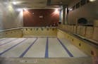 The pool at Phillips Community Center sat empty and closed through a through a viewing window.