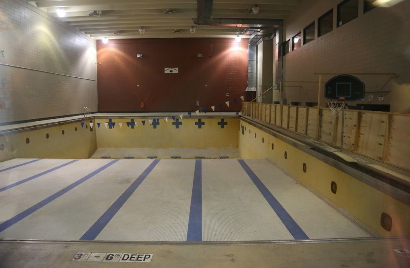 The pool at Phillips Community Center sat empty and closed through a through a viewing window.