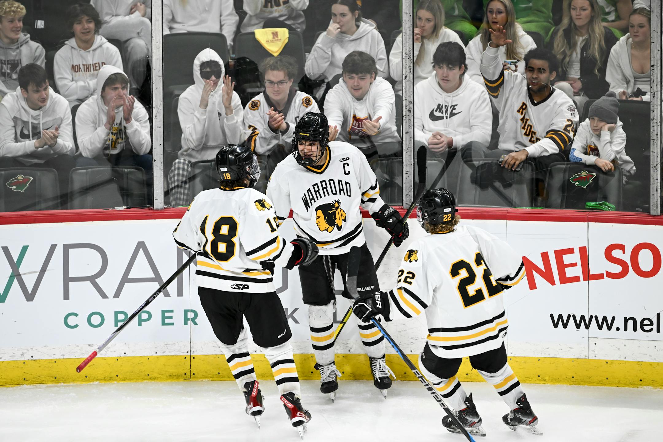 From left, Warroad forward Carson Pilgrim (18), forward Jayson Shaugabay (17) and forward Murray Marvin-Cordes (22) celebrate a goal by Shaugabay during the third period.