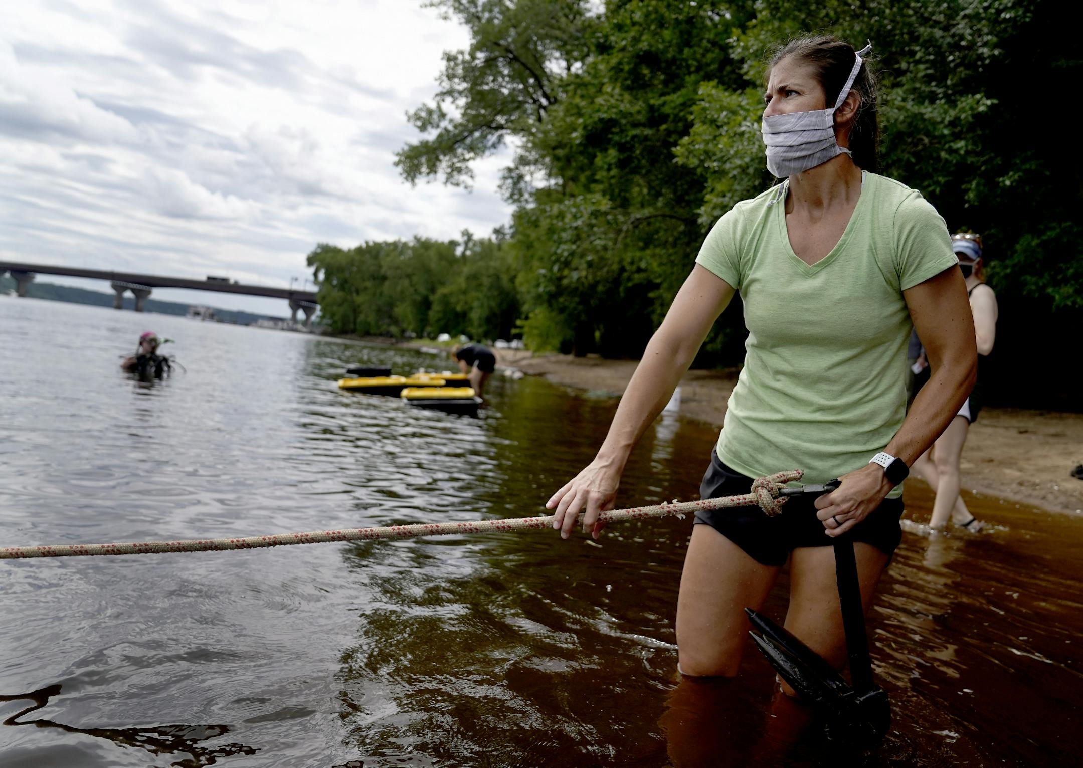 Minnesota DNR employees transplanted 3,506 mussels native to Minnesota -- including Higgins' eye, bucket and snuffbox-- to grow in the waters of the St. Croix River, across from Hudson, WI, Tuesday in Lakeland, MN. Here, Madeline Pletta, a mussel propagation biologist with the Minnesota Department of Natural Resources, holds a line attached to a diver who was trying to locate a bed of mussels transplanted in the St. Croix last year.
