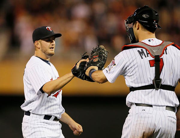 Twins closer, Glen Perkins and Joe Mauer celebrated their win against the Phillies at Target Field