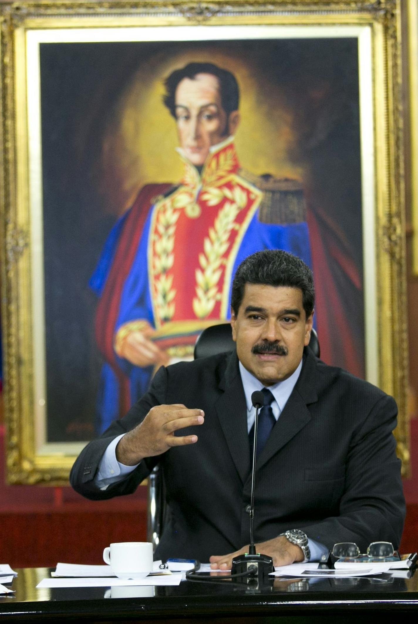 Backdropped by live reconstructions and a painting of independence hero Simon Bolivar, Venezuela's President Nicolas Maduro speaks during a press conference at Miraflores presidential palace in Caracas, Venezuela, Wednesday, Jan. 18, 2017. The main opposition coalition marched to call on the Organization of American States to intervene in Venezuela's political crisis. (AP Photo/Ariana Cubillos) ORG XMIT: XAC108