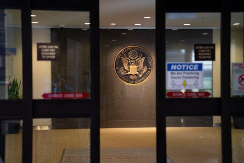 Automatic sliding doors close the entrance to the Warren E. Burger Federal Building and U.S. Courthouse, where Wilfred was sentenced Thursday.