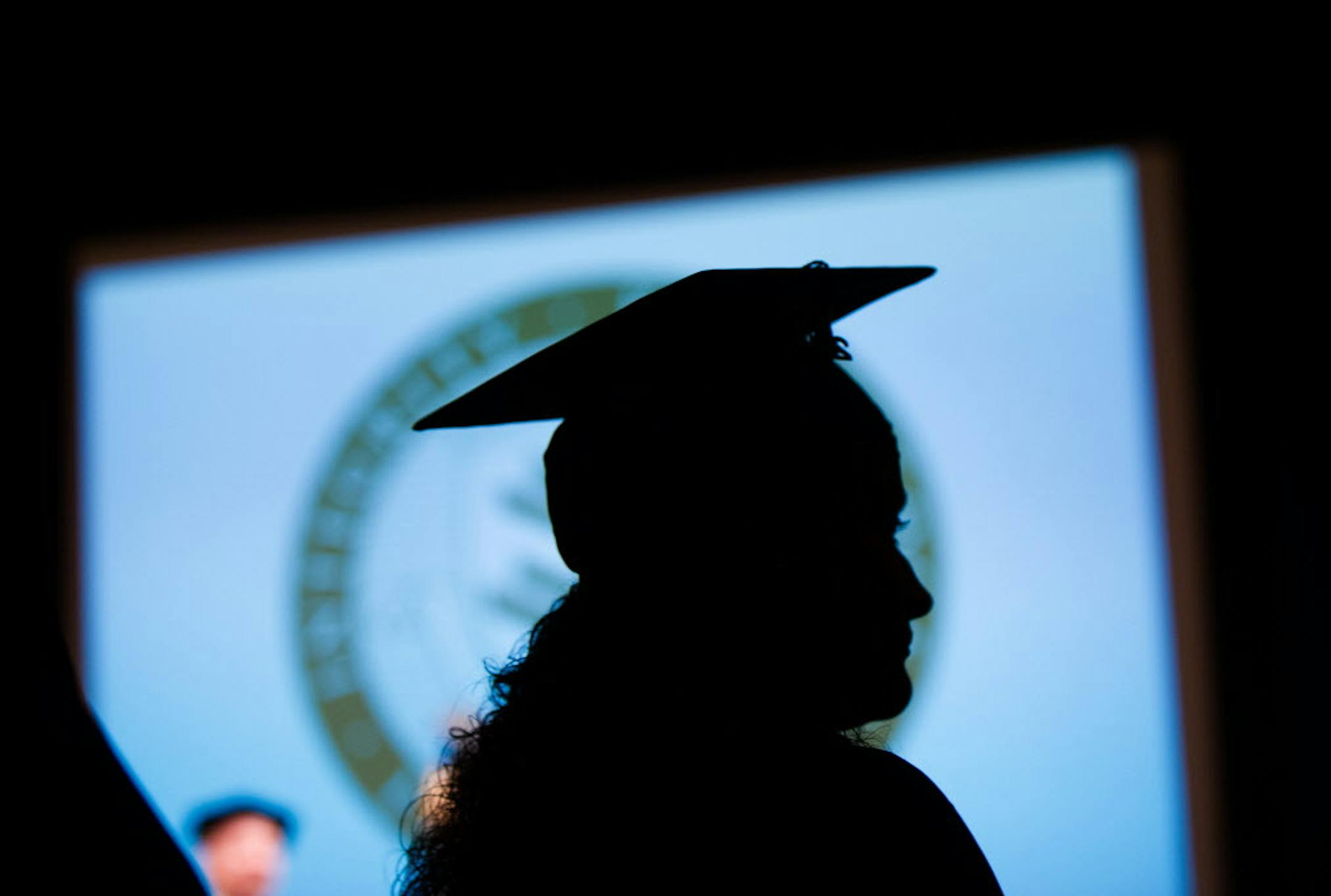 A member of the New England College of Business graduating class of 2014 stands during commencement exercises in Boston, Saturday, May 17, 2014. Gretchen Ertl/AP Images for New England College of Business