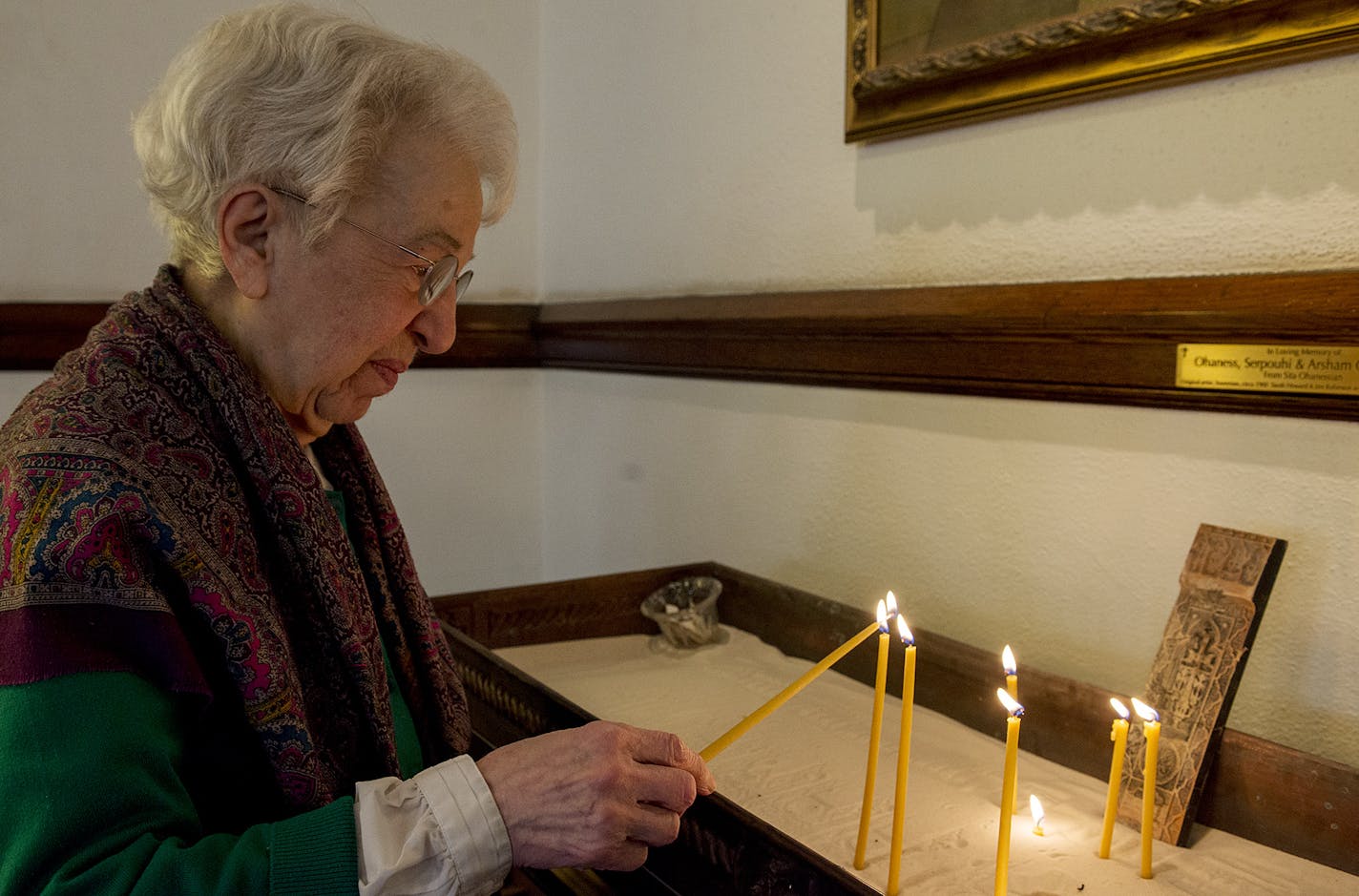 Harriet Balian lights a candle.] BRIDGET BENNETT SPECIAL TO THE STAR TRIBUNE &#x2022; bridget.bennett@startibune.com Sunday, April 12, 2015 during a church service at St. Sahag Armenian Church in St. Paul, MN. Harriet Balian's parents survived the genocide. One hundred years ago this month, the first of 1.5 million Armenians were killed by the Ottoman Turk. St. Sahag Armenian Church is a hub of the Armenian community.