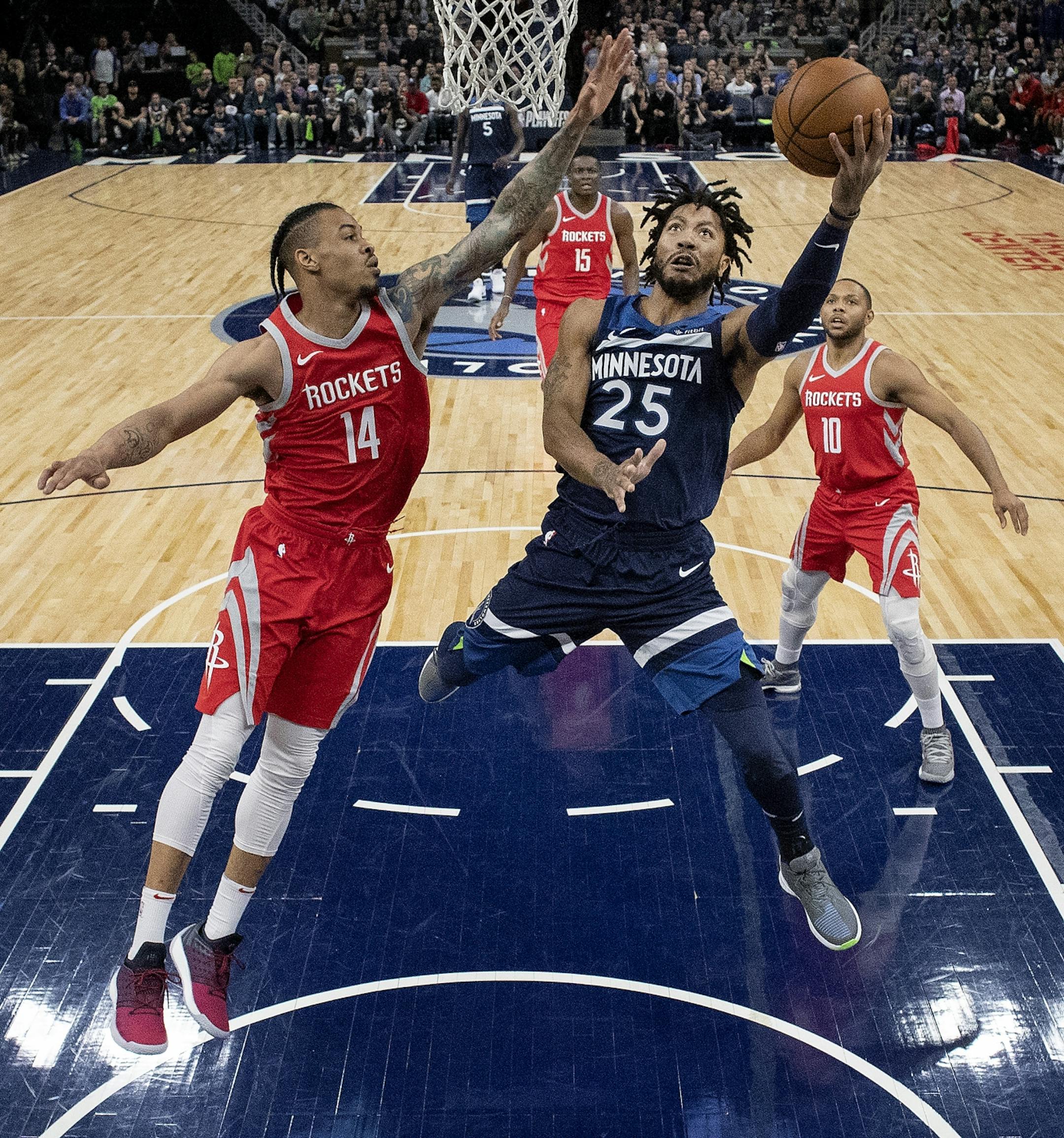 Minnesota Timberwolves Derrick Rose (23) attempted a shot while being defended by Gerald Green (14) in the first half.