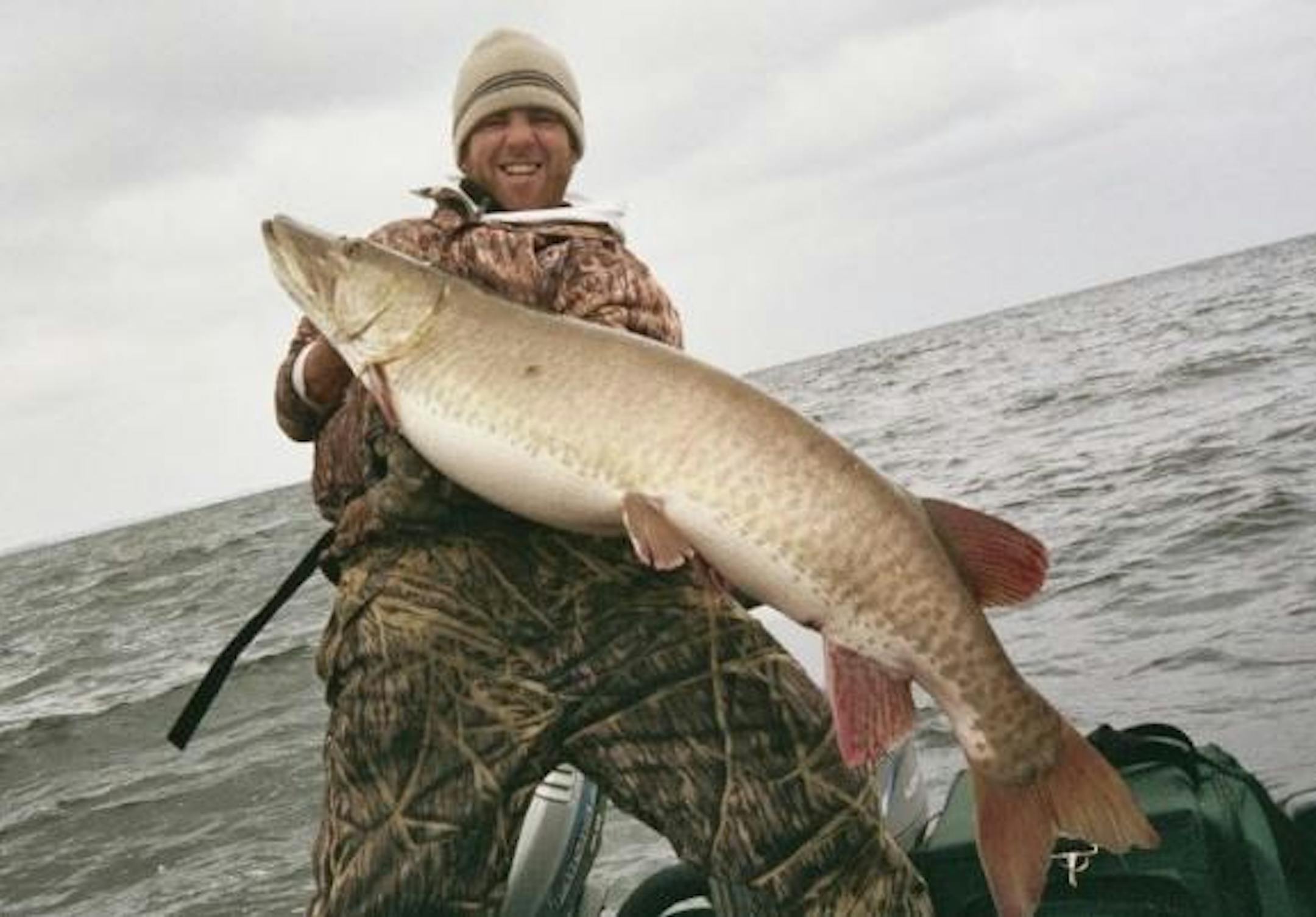 The author, Travis Frank, hoists a near record breaking muskie caught during a November muskie trip - this beast is the object of his effection!