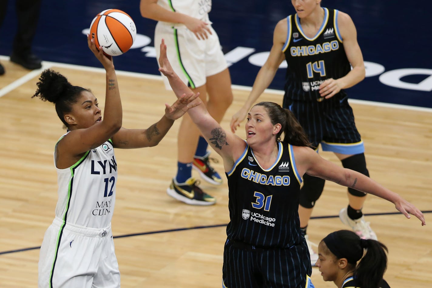 Minnesota Lynx forward Damiris Dantas (12) shoots as Chicago Sky center Stefanie Dolson (31) defends during the second half of a WNBA basketball game Tuesday, June 15, 2021, in Minneapolis. Chicago won 105-89. (AP Photo/Stacy Bengs)