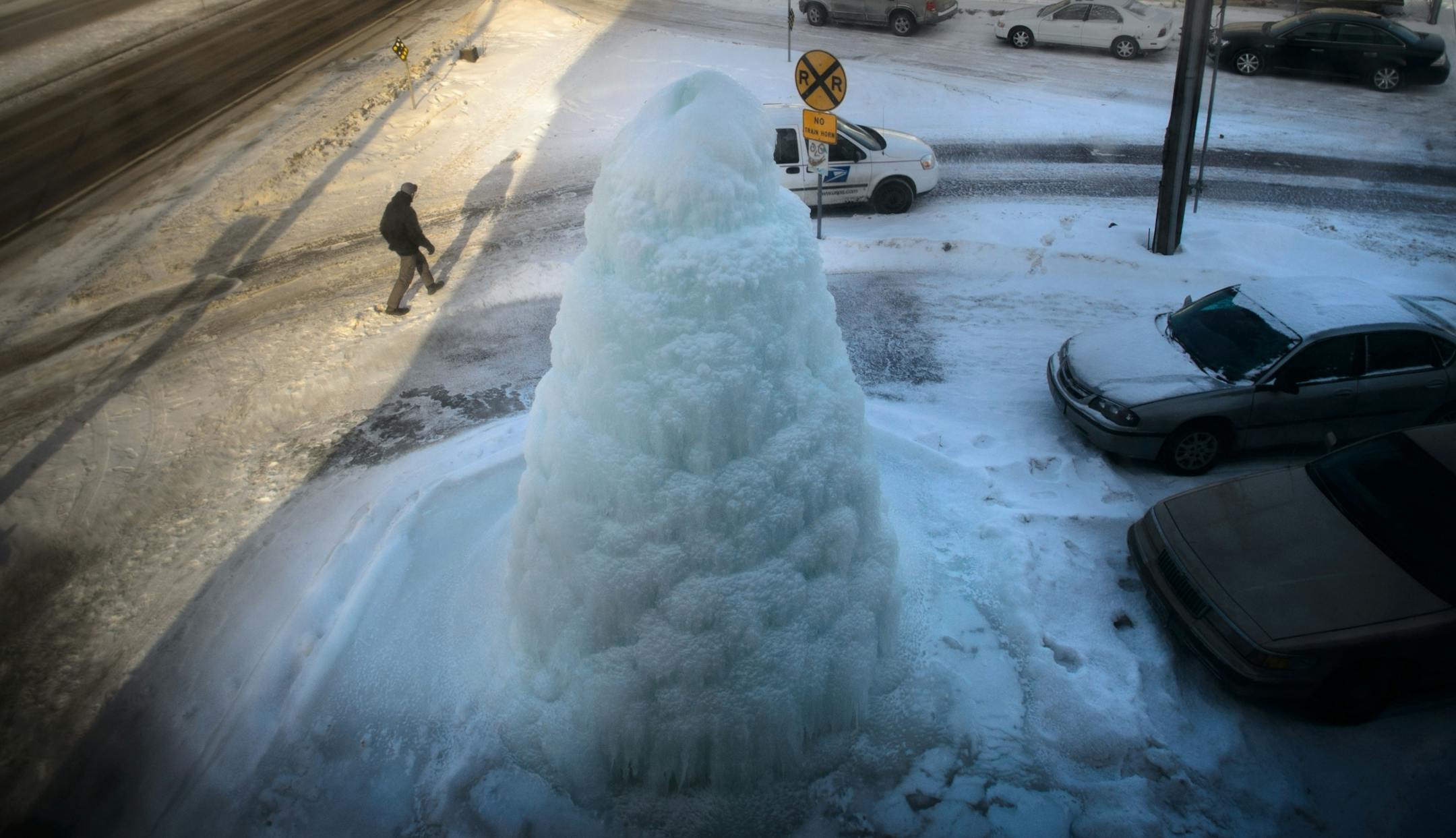A postal worker delivered the mail to Flair Fountains. Flair Fountains takes great pride in running the fountain outside its Minneapolis headquarters 365 days a year. It was running today even at -16 degrees. They have to keep it turned down so the ice mountain doesn't spill out onto Hiawatha Ave. Monday, January 6, 2014