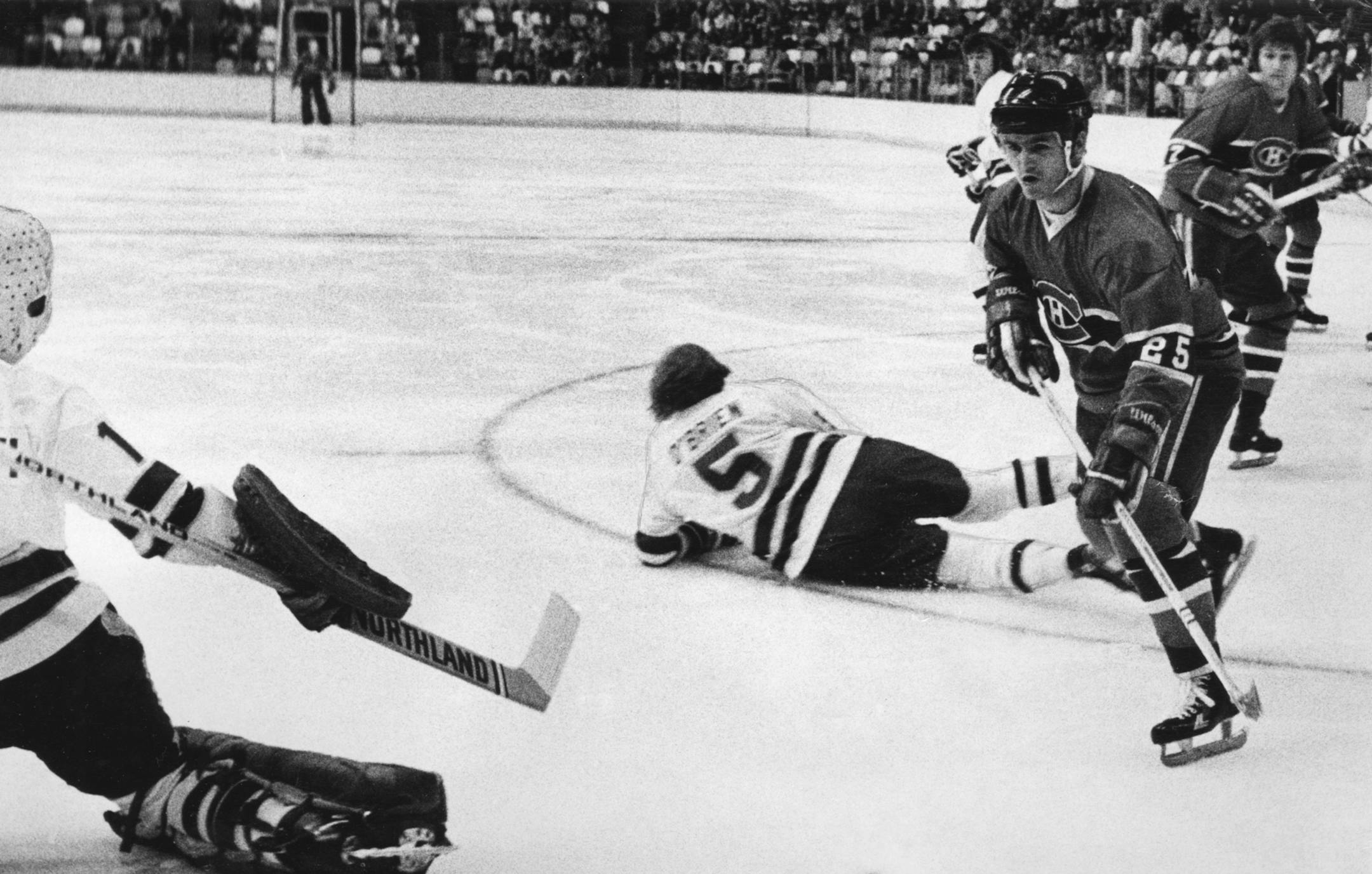North Stars' goalie Pete LoPresti went to his knees and defenseman Dennis O'Brien (5) went flat on the ice to foil this Montreal rush by Jacques Lemaire, Nov. 19, 1975. Minneapolis Tribune staff photo by Pete Hohn.