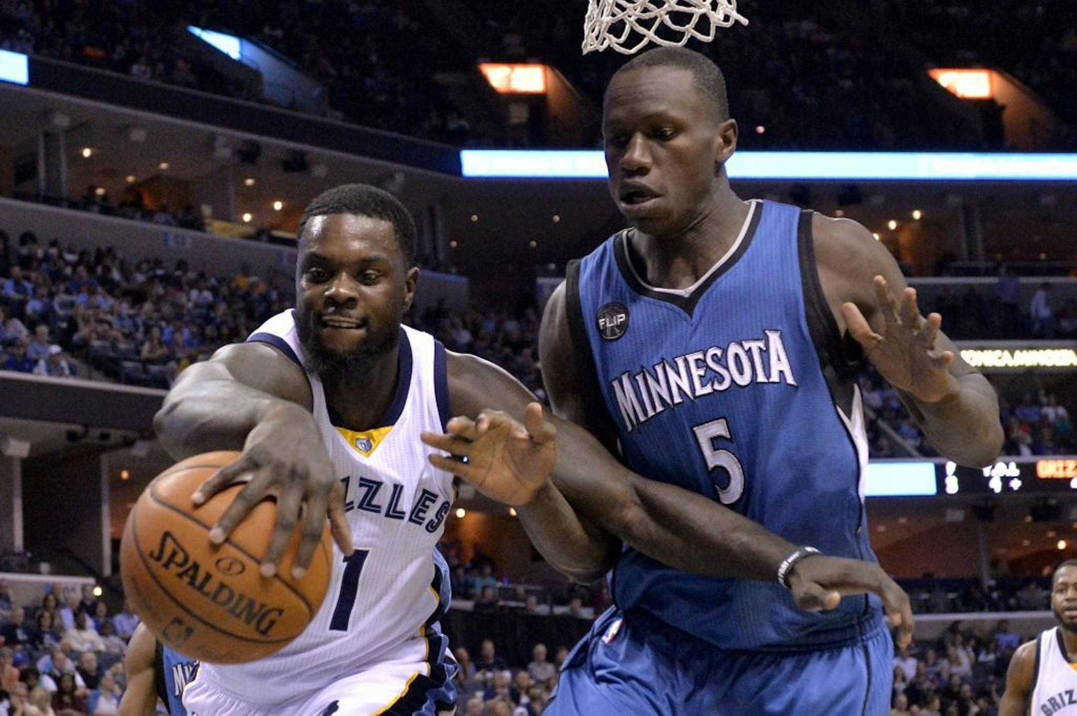 Memphis Grizzlies forward Lance Stephenson (1) and Minnesota Timberwolves center Gorgui Dieng (5) vie for control of the ball in the first half of an NBA basketball game Wednesday, March 16, 2016, in Memphis, Tenn.