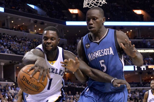 Memphis Grizzlies forward Lance Stephenson (1) and Minnesota Timberwolves center Gorgui Dieng (5) vie for control of the ball in the first half of an 