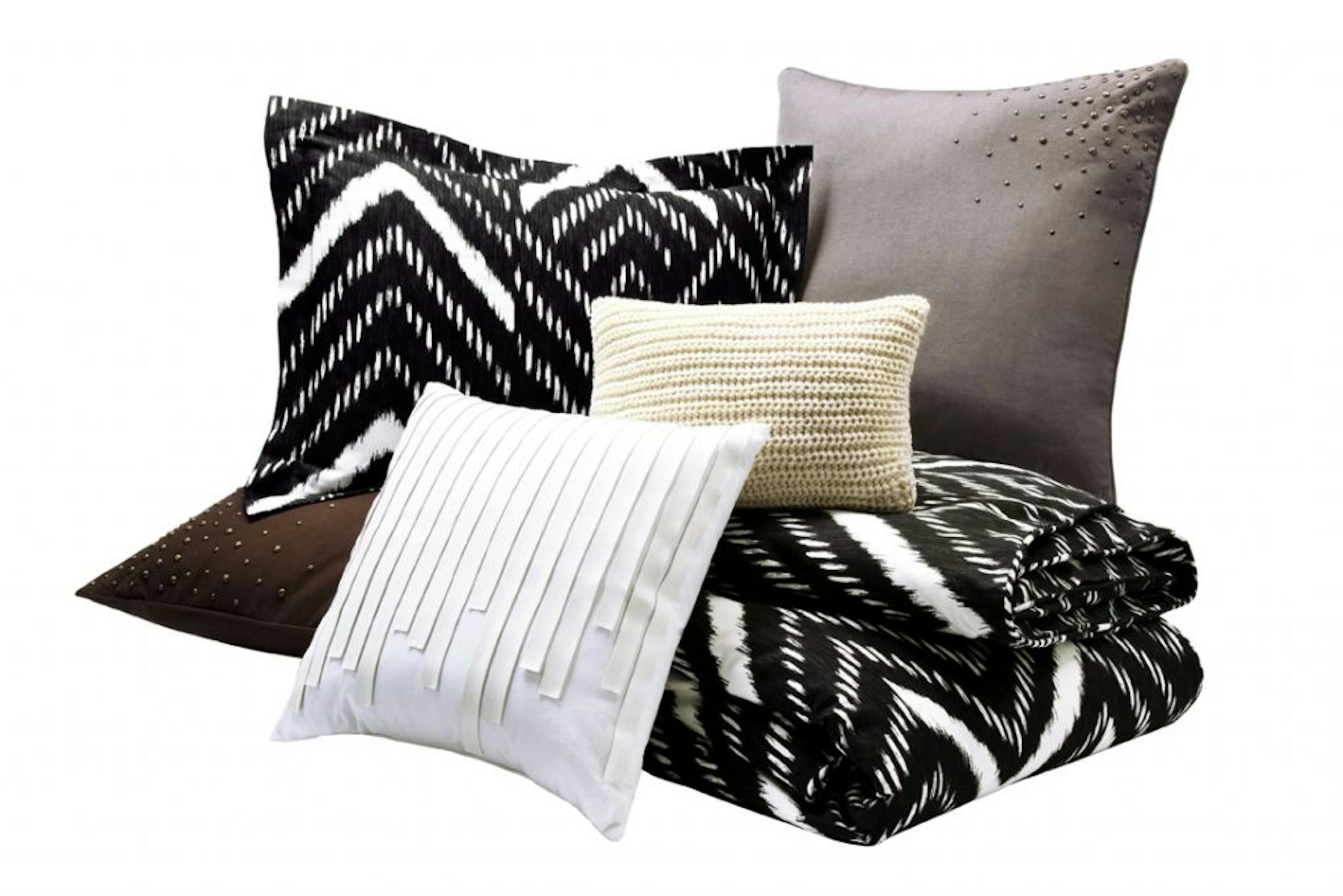 Nate Berkus designer for Target. Nate Berkus Mini Nepal Chevron Duvet Set in Onyx - $89.99 (full/queen) Nate Berkus Saville Row Pillow in White - $24.99 Nate Berkus Chunky Knit Pillow in Cream with Gold-Detailing - $24.99 Nate Berkus Scattered Stud Pillow in Charcoal and Chocolate - $34.99 each
