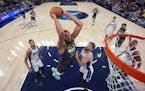 Minnesota Timberwolves center Rudy Gobert (27) goes up for dunk as Sacramento Kings forward Domantas Sabonis, center right, defends during the second 