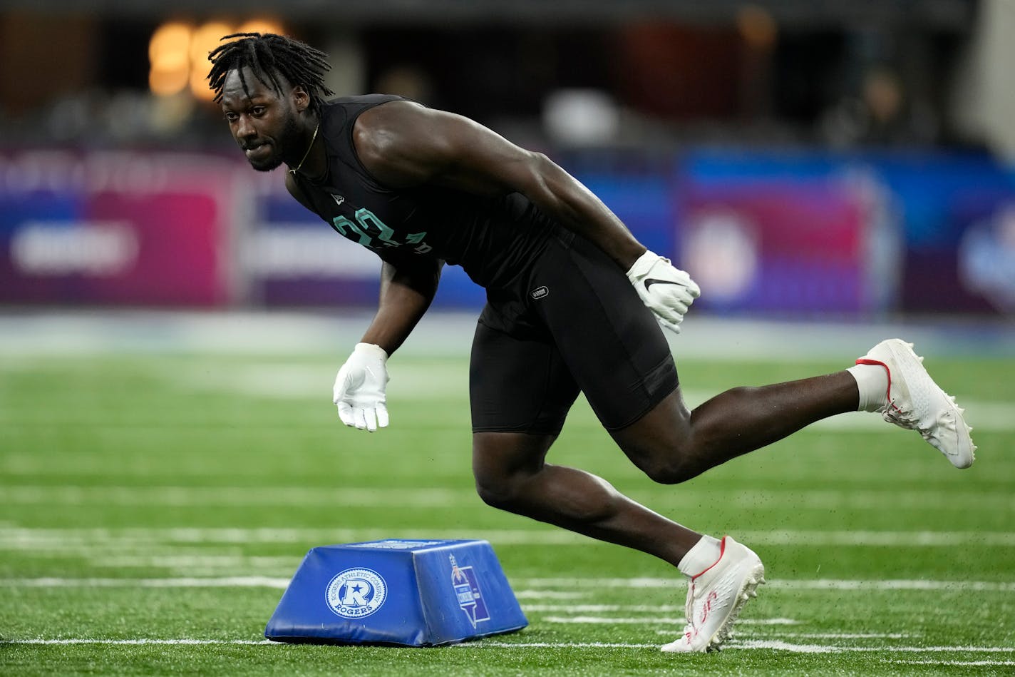 Utah linebacker Devin Lloyd runs a drill at the NFL football scouting combine, Saturday, March 5, 2022, in Indianapolis. (AP Photo/Charlie Neibergall)