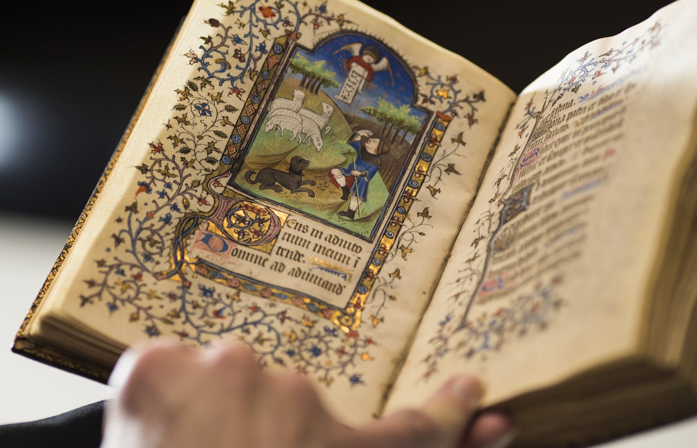 Fr. Columba Stewart held a 14th century book of hours from France at St. John's University in Collegeville, Minn., on Friday, December 1, 2017. Stewart has spent the past 20 years traveling the globe to unearth historically significant ancient writings and digitizing them. ] RENEE JONES SCHNEIDER &#x2022; renee.jones@startribune.com