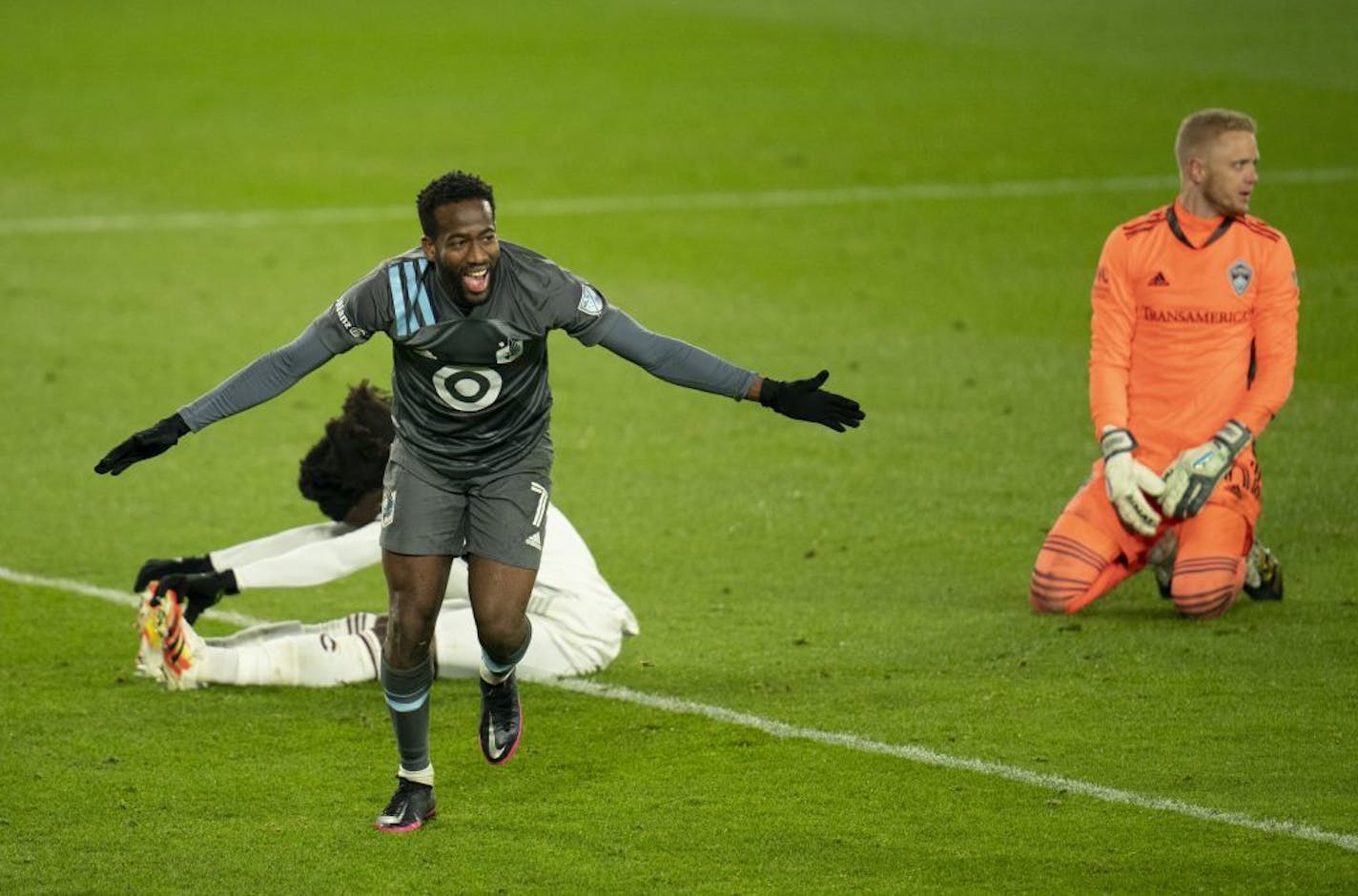 Minnesota United midfielder Kevin Molino (7) celebrates his second goal after beating Colorado Rapids goalkeeper William Yarbrough, right, during an MLS first-round playoff soccer match Sunday, Nov. 22, 2020, in St. Paul, Minn.