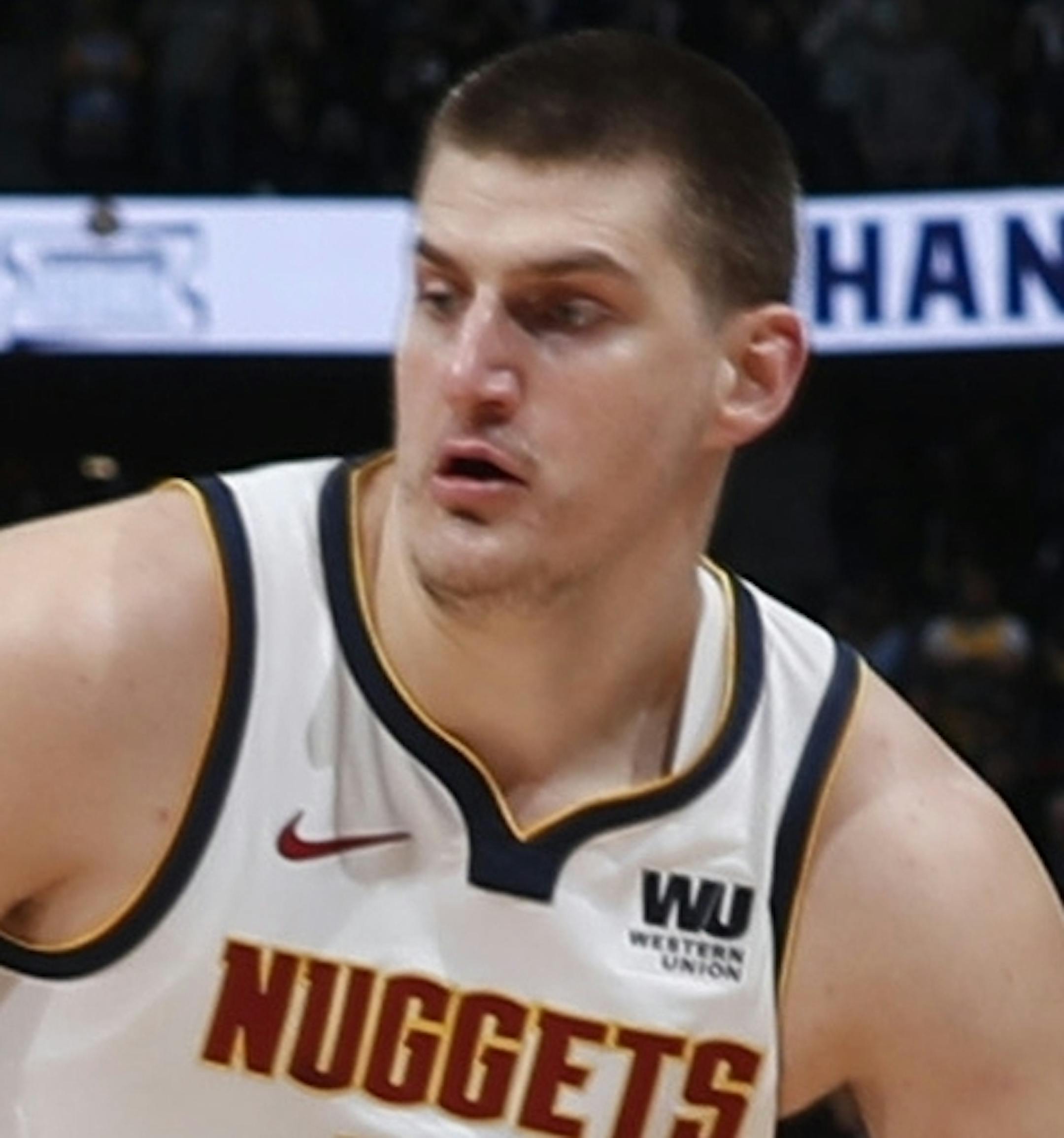 Denver Nuggets center Nikola Jokic, right, drives to the rim as Portland Trail Blazers forward Al-Farouq Aminu defends in the first half of Game 5 of an NBA basketball second-round playoff series, Tuesday, May 7, 2019, in Denver. (AP Photo/David Zalubowski)