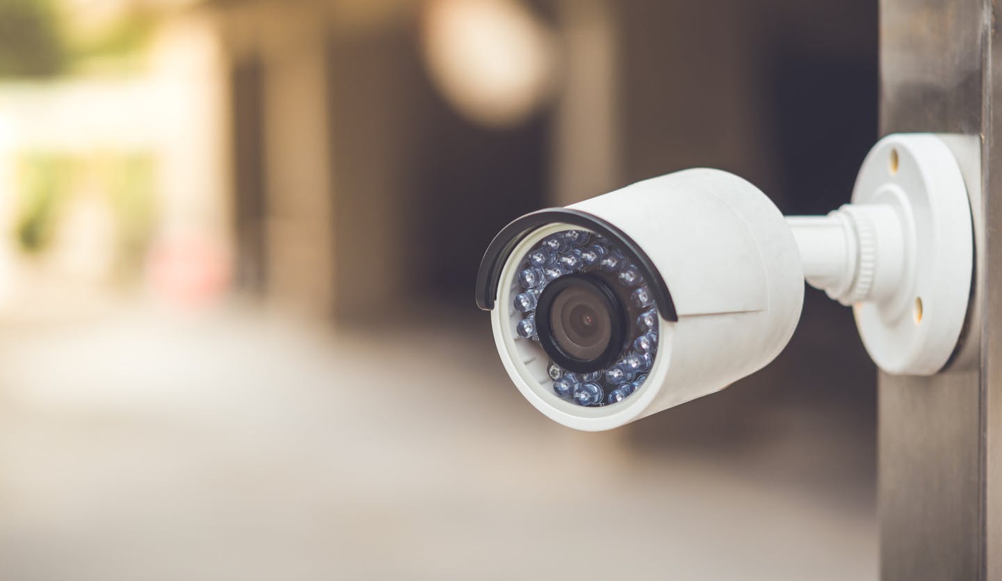 White cctv outside the building, security system with vintage color tone