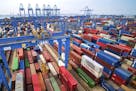 In this Tuesday, May 14, 2019, photo, containers are piled up at a port in Qingdao in east China's Shandong province. China's imports from the United 