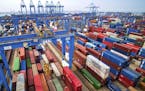 In this Tuesday, May 14, 2019, photo, containers are piled up at a port in Qingdao in east China's Shandong province. China's imports from the United 