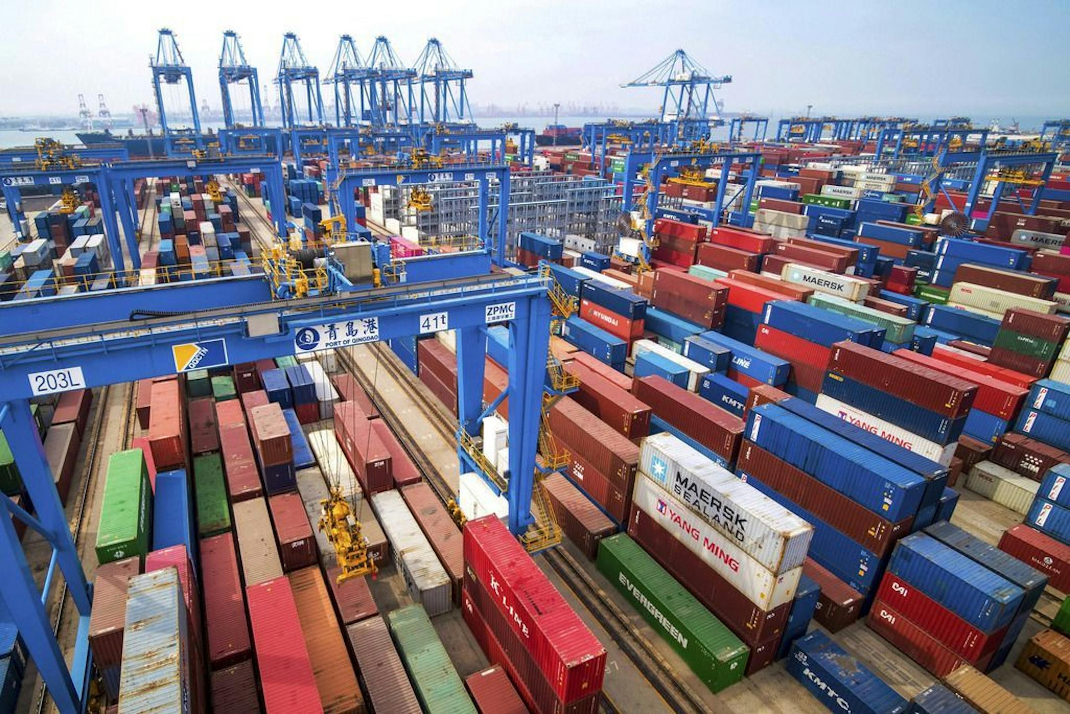 In this Tuesday, May 14, 2019, photo, containers are piled up at a port in Qingdao in east China's Shandong province. China's imports from the United States plunged 31.4% in June from a year earlier amid a tariff war with Washington, while exports to the U.S. market sank 7.8%, Customs data showed Friday, July 12, 2019.