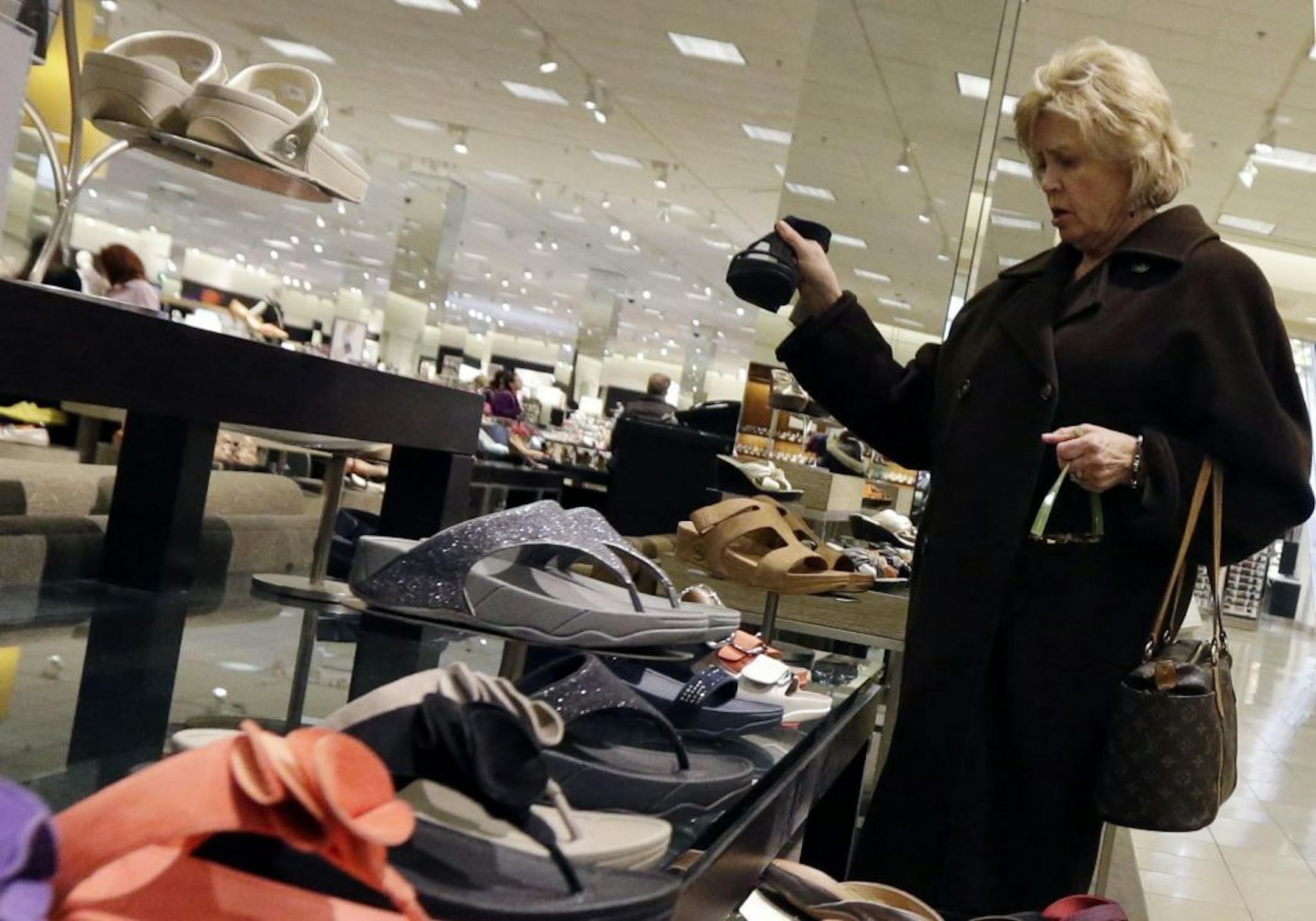 In this Thursday, March 28, 2013, photo, a woman shops at a store in Chicago. The government reports how much consumers spent and earned in March on Monday, April 29, 2013.