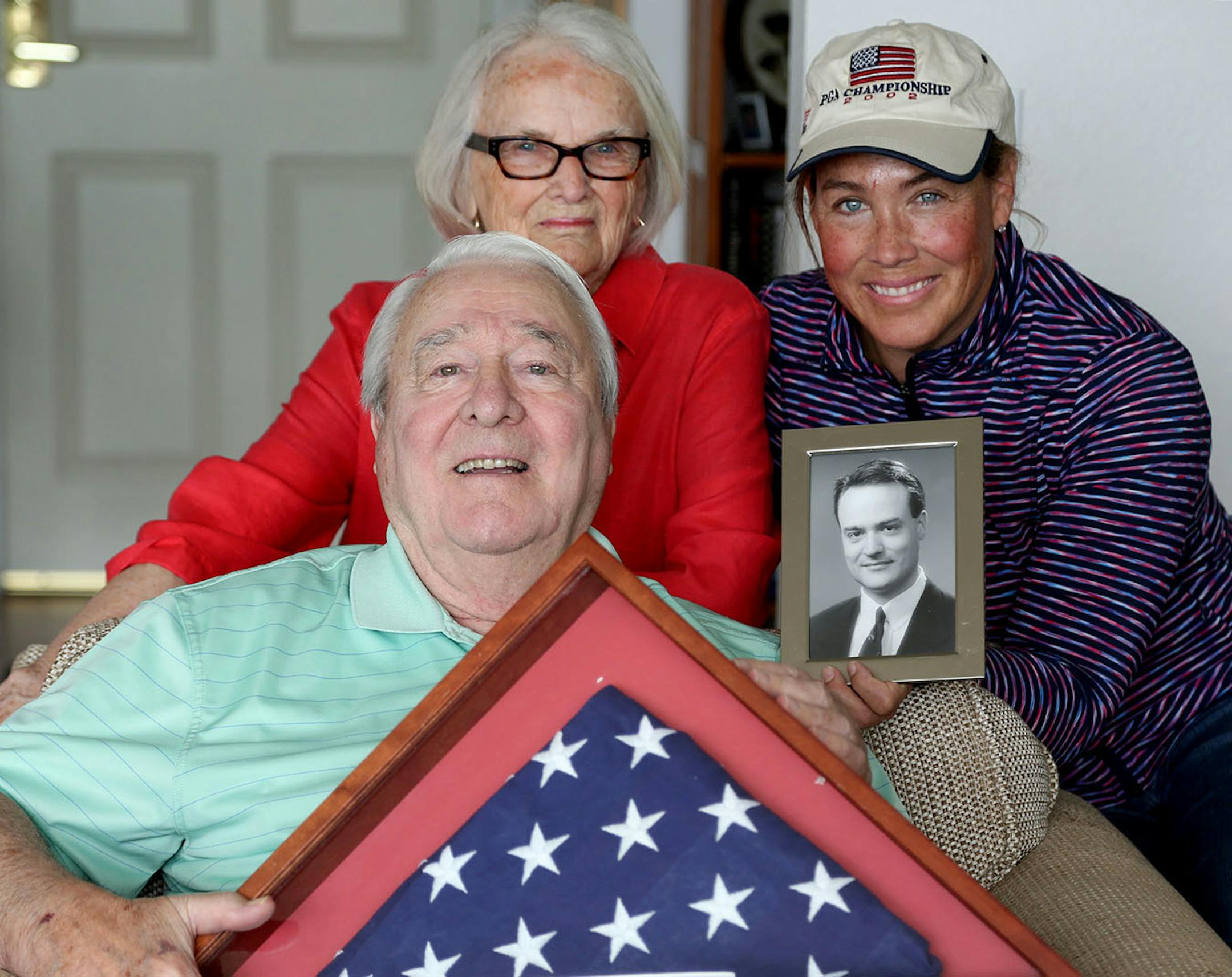 Tom and Bev Burnett with their youngest child Mary Margaret Jurgens. Jurgen's held a picture of her brother Tom Burnett Jr. while Tom Sr. held a flag given to the family that was flown over the Capitol. The family is giving historical societies some of Tom jr., memorabilia. Jurgen's said she hoped that can inspire other people.