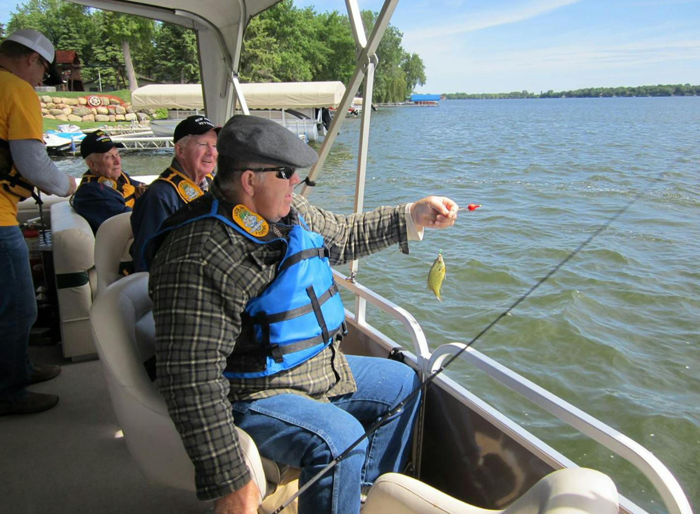 (From left to right) Bill Kajer, Joe Vaughan and Larry Smith enjoy a ride on the Scott County chapter of Let's Go Fishing with Seniors' pontoon boat June 1 at Cedar Lake in New Prague. Photo by Janice Bitters