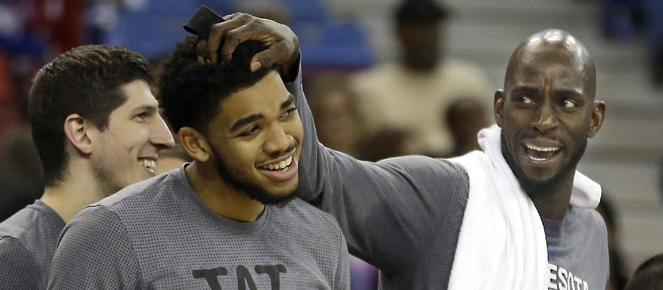 FILE - In this Nov. 27, 2015, file photo, Minnesota Timberwolves forward Kevin Garnett, right, rubs the head of teammate Karl-Anthony Towns as they celebrate during the closing moments of the Timberwolves' 101-91 win over the Sacramento Kings in an NBA basketball game in Sacramento, Calif. Less than a week before training camp begins, the Timberwolves have not heard from Garnett on his desires for the upcoming season. With that silence in mind, the team has started to explore scenarios that incl