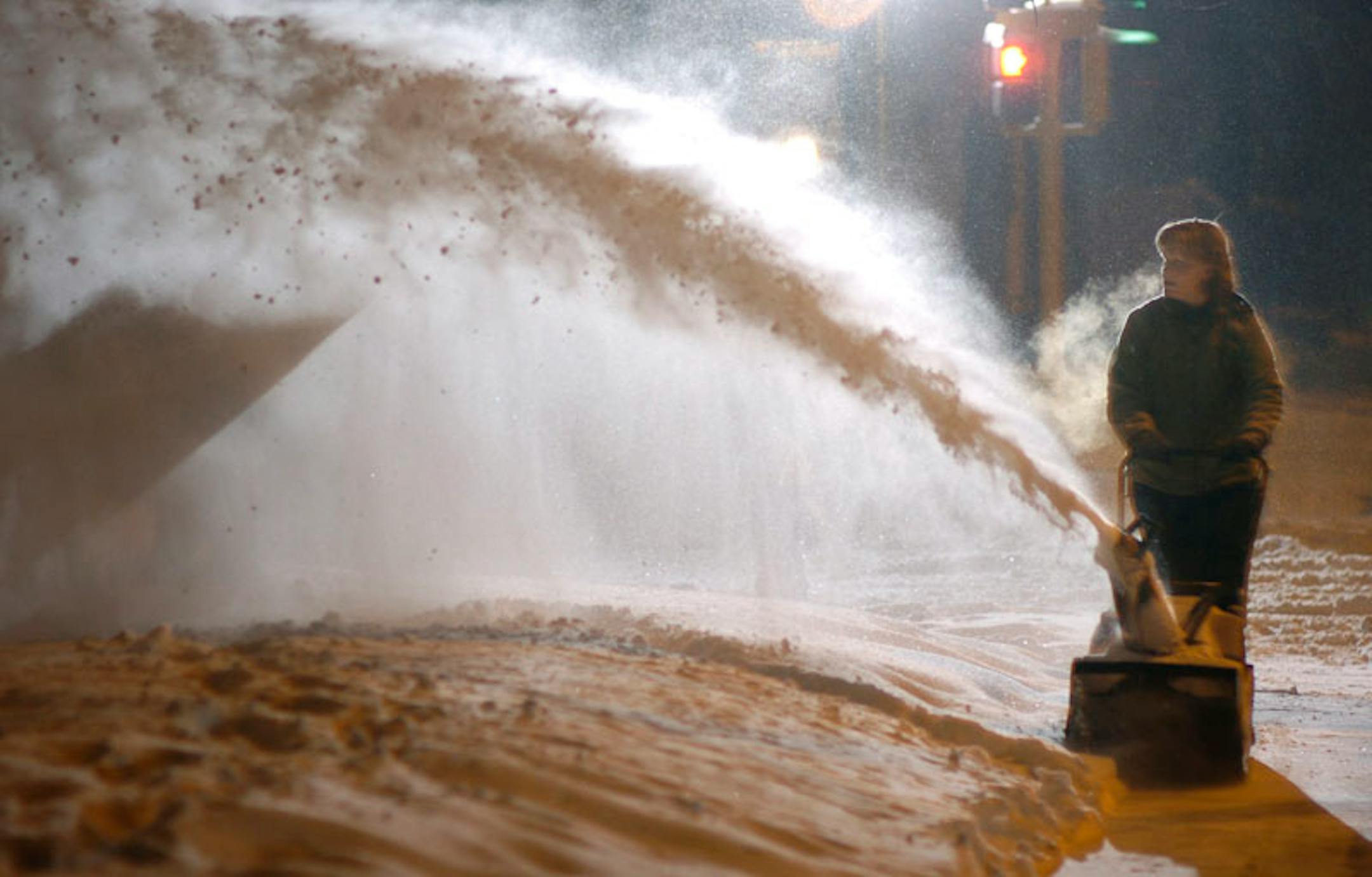 SUNDAY_02/01/04_St.Paul - - - - - - Sundays snow accumulation brought out the snowblowers early Sunday evening. Seen here is Barb Bates (St.Paul) keeping an eye on her grandson, Andrew Bates (6 yrs.old - not visable in photo) while she clears her sidewalk.