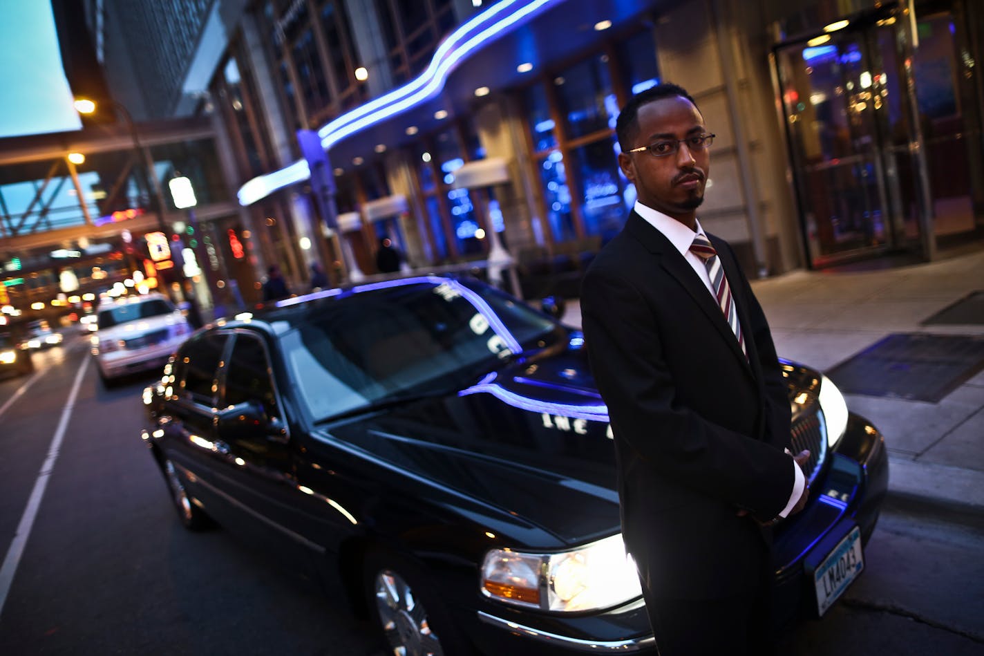 Driver Wami Osman stood outside one of Uber's cars in 2012 when the service launched in the Twin Cities.