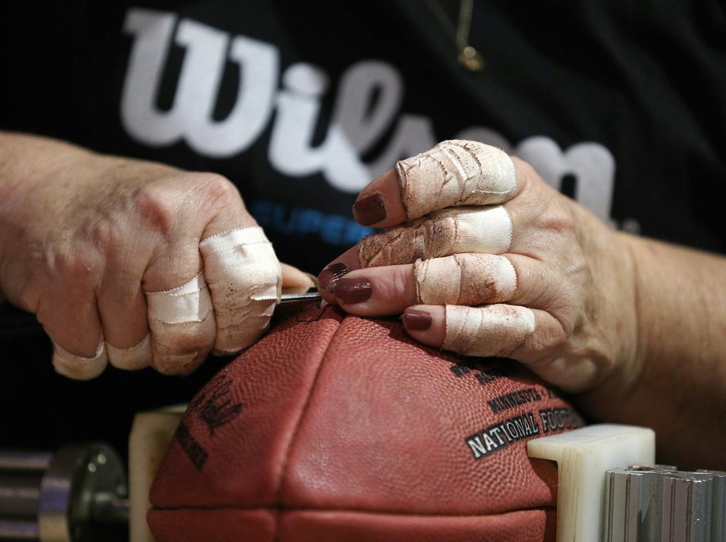 Pamela Boutwell with Wilson laced a football as fans watched them being made.