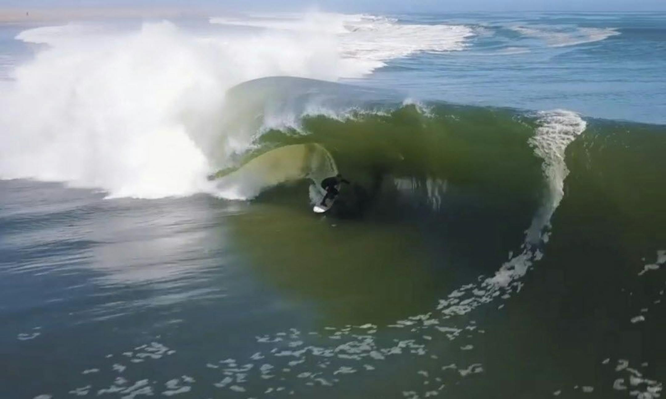 In this image made from video provided by Chris Rogers, surfer Koa Smith rides a wave off the coast of Namibia, on the Western shore of Africa. Smith rode for nearly a mile over a 120-second span and stayed upright as he traveled through eight barrels--the hollow formed by the curve of the wave as it breaks over the surfer's head.
