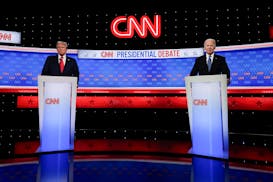 President Joe Biden, right, and Republican presidential candidate former President Donald Trump, left, stand during a break in a presidential debate h