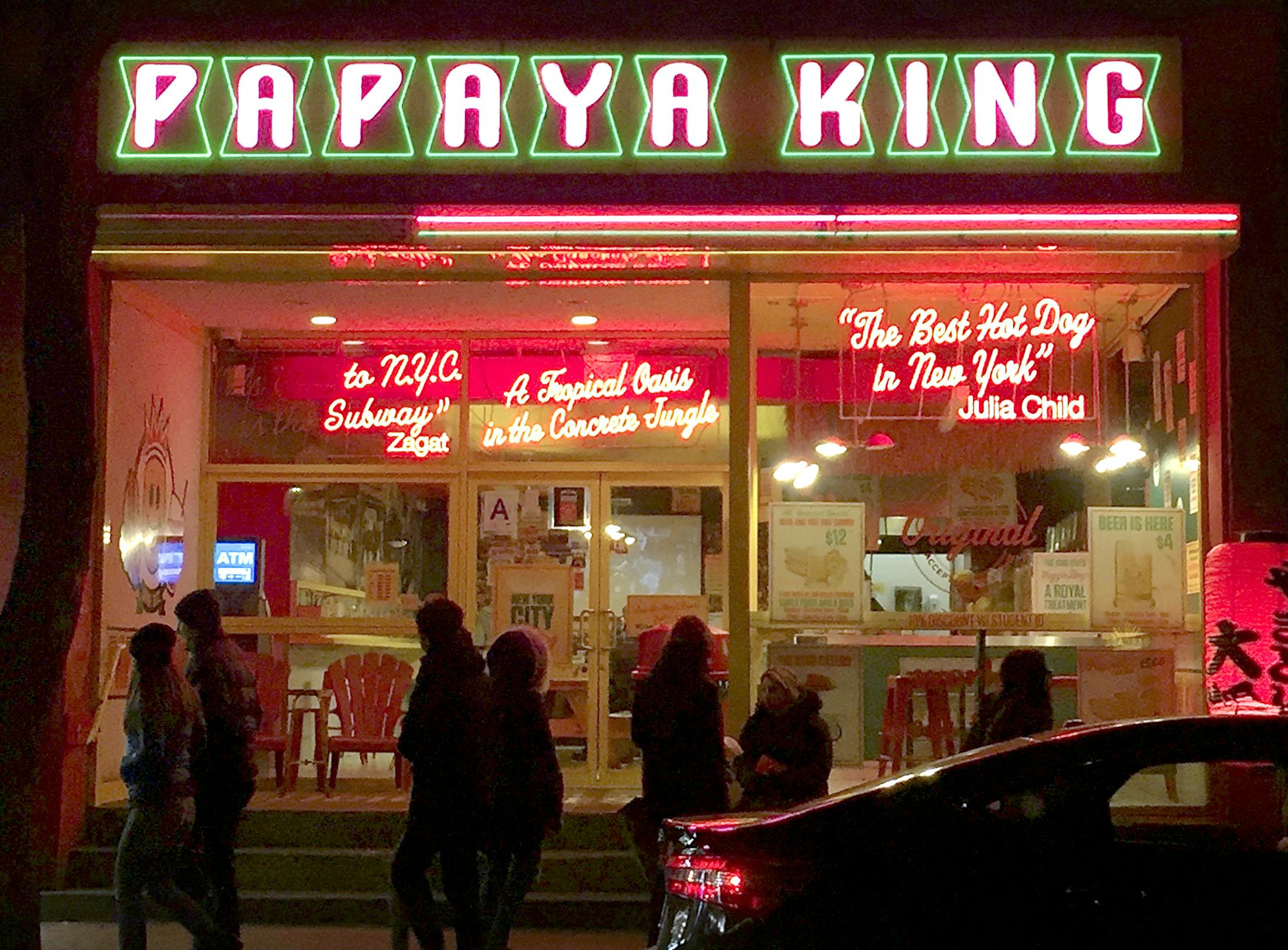 Papaya King glows with neon at the head of St. Marks Place.