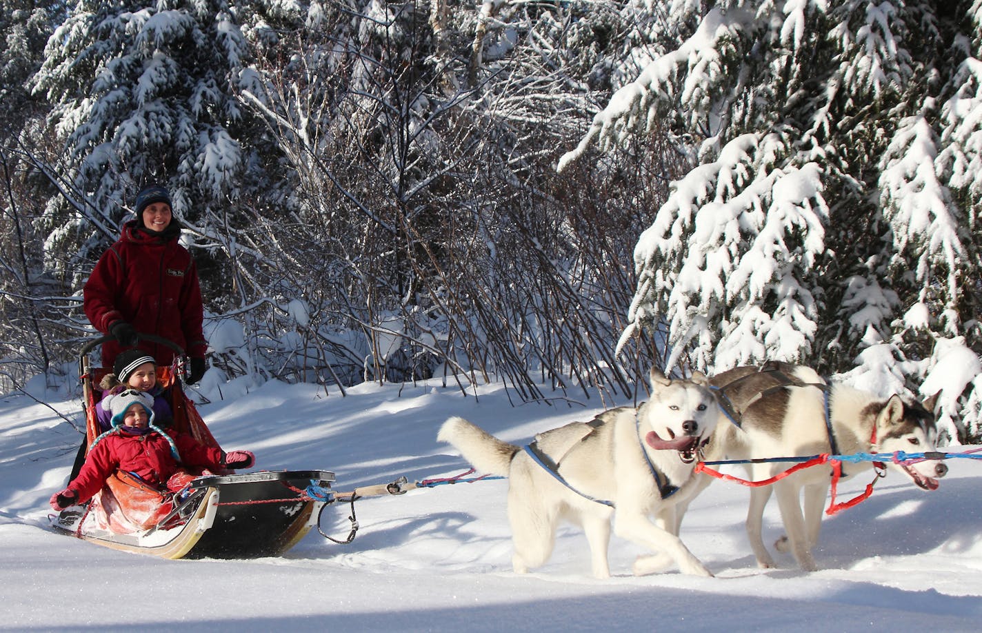 Jen Freking and daughters, Elena and Nichole, enjoy a ride on the trails around their home, Manitou Crossing Kennels.