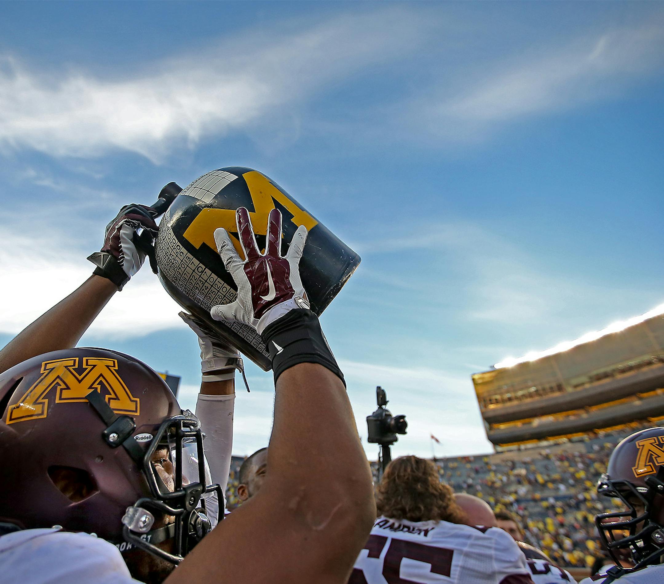 Minnesota running back David Cobb (27) grabbed the Little Brown Jug after helping defeat Michigan 30-14 at Michigan Stadium, Saturday, September 27, 2014 in Ann Arbor, MI. ] (ELIZABETH FLORES/STAR TRIBUNE) ELIZABETH FLORES • eflores@startribune.com